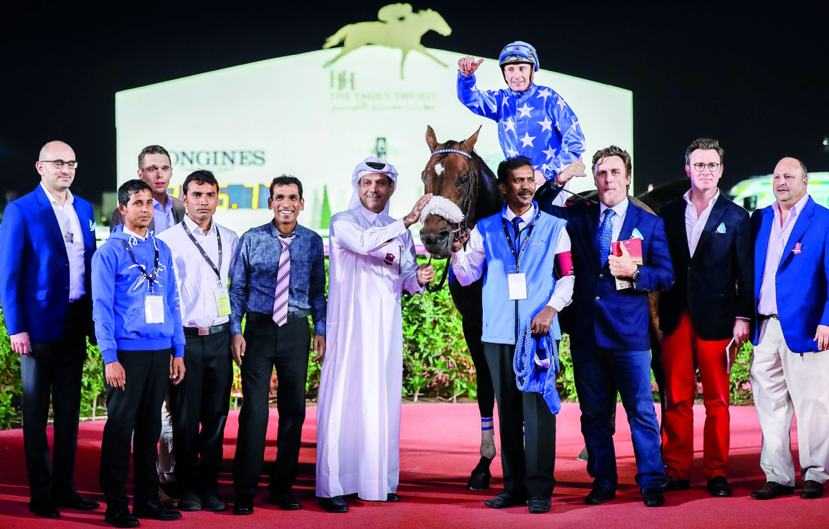 Jockey Theo Bachelot celebrates with Reda trainer Julian Smart and team members after winning Al Zubara Trophy. 