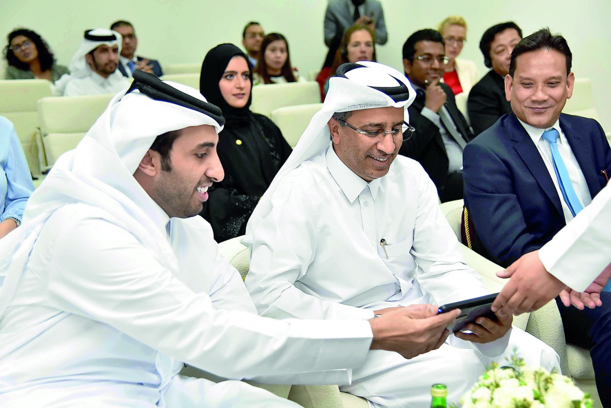 Minister of Justice H E Dr Hassan bin Lahdan Al Mohannadi launching  the  eCourt system yesterday. Faisal Rashid Al Sahouti, CEO of QICDRC, and Saw Ken Wye, CEO of CrimsonLogic, were also present. 