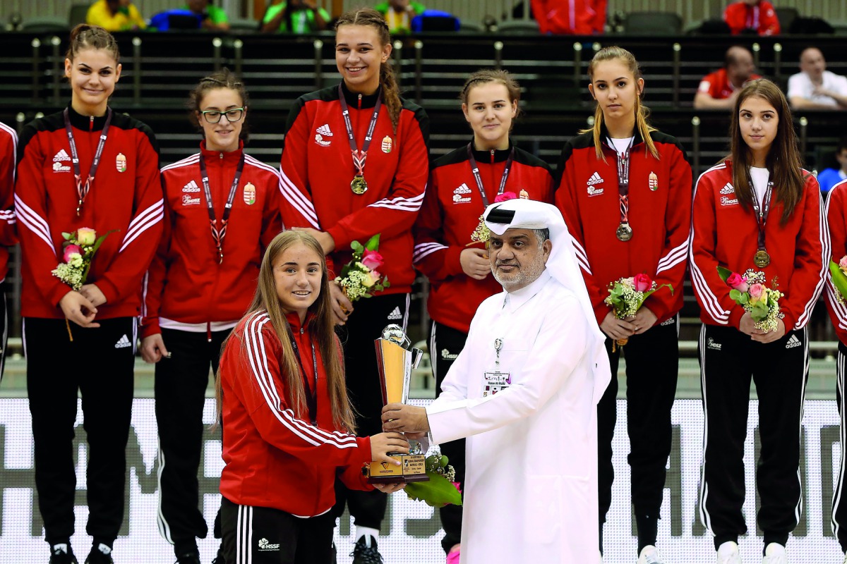 The captain of the Hungarian team receiving the Girls’ Championship title during the presentation ceremony yesterday.