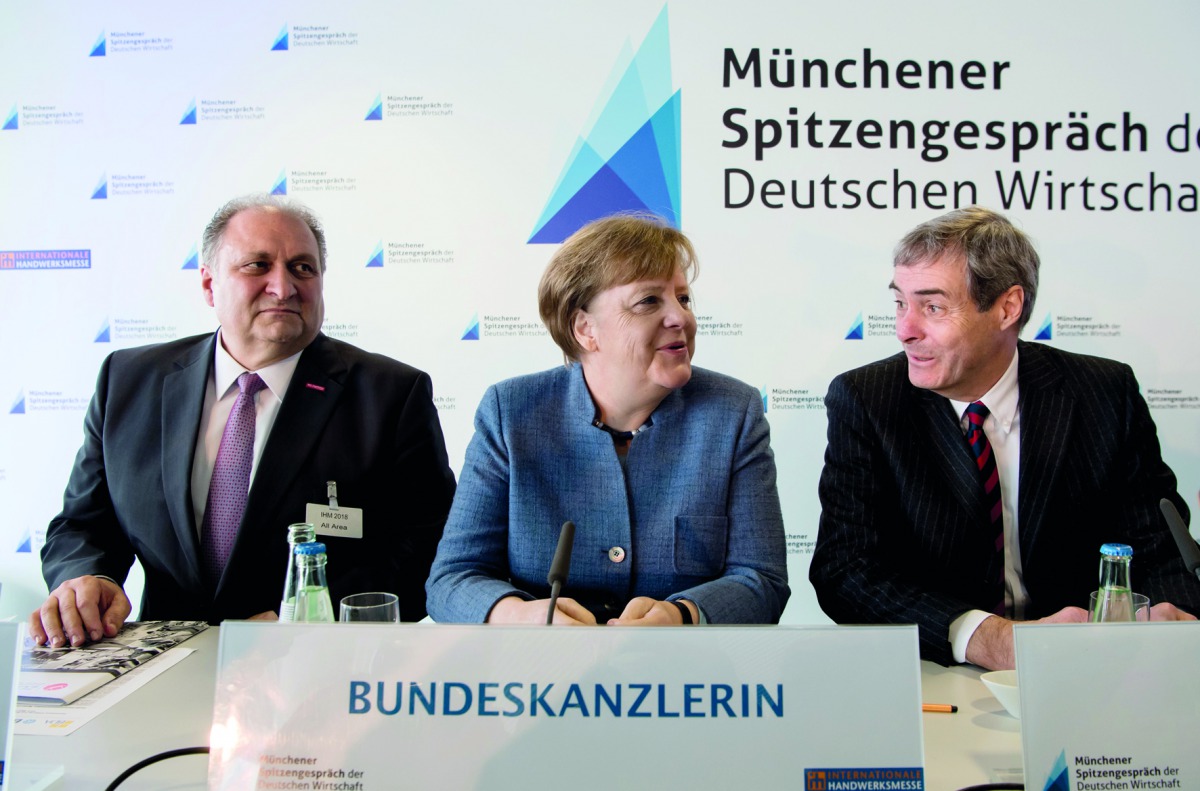 President of the German Confederation of Skilled Crafts (ZDH), Hans Peter Wollseifer, German chancellor Angela Merkel and head of the Confederation of German Employers' Associations (BDA), Ingo Kramer attend German economy summit talks in Munich on March 