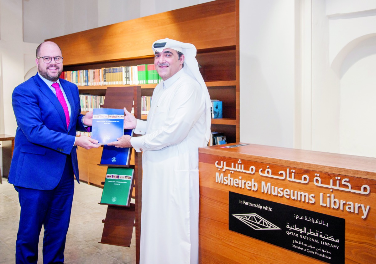 Ryan Gliha (left), Charge  d’Affaires of the US Embassy, presenting the report to the Director of Msheireb Museums, Hafiz Ali. 
