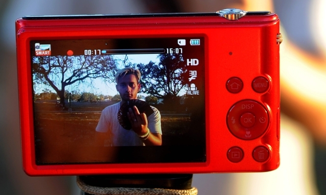 A Cuban youtuber records a magician's performance for her youtube channel in Havana, on February 26, 2018.  AFP / Yamil Lage