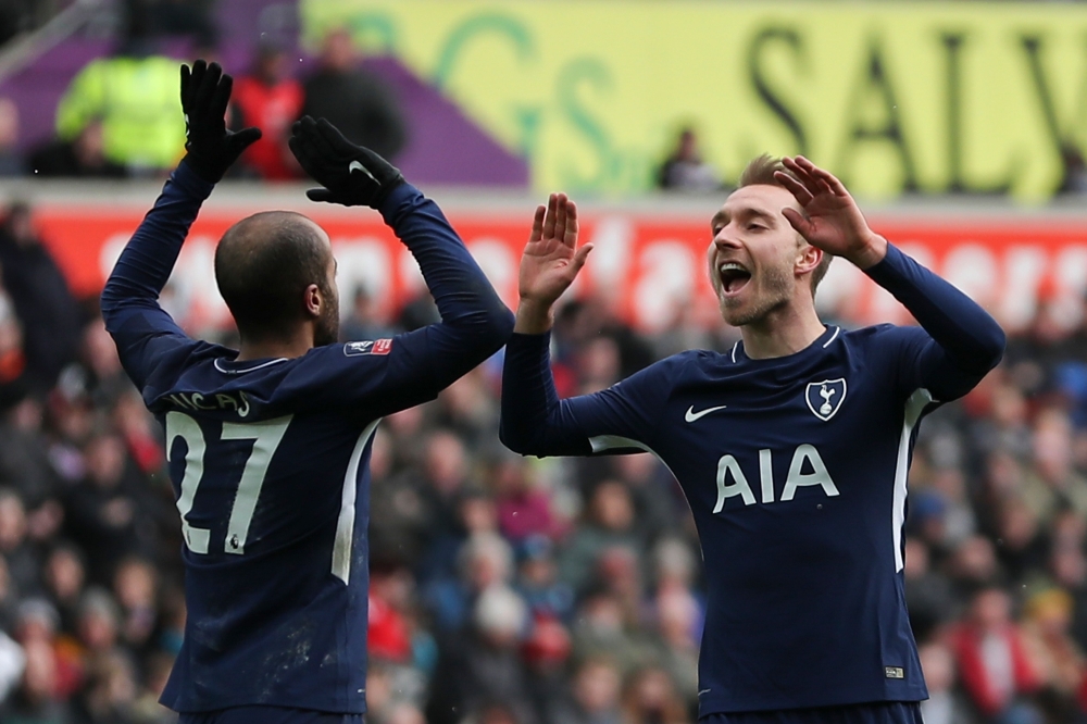 Tottenham Hotspur's Danish midfielder Christian Eriksen (R) celebrates scoring their third goal with Tottenham Hotspur's Brazilian midfielder Lucas Moura (L) during the English FA Cup quarter-final football match between Swansea City and Tottenham Hotspur