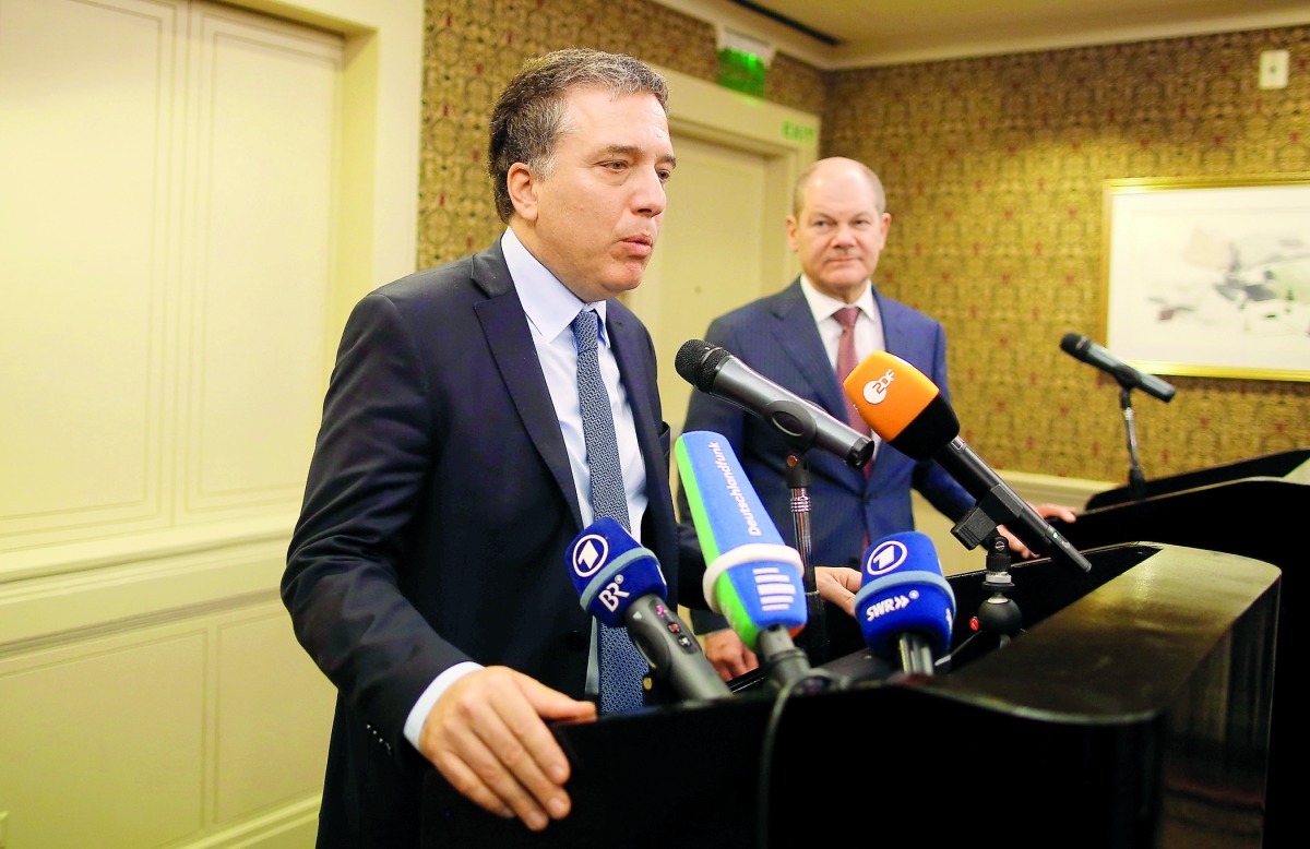 Argentina's Treasury Minister Nicolas Dujovne attends a news conference next to Germany's Finance Minister Olaf Scholz during the 2018 G20 Conference entitled 