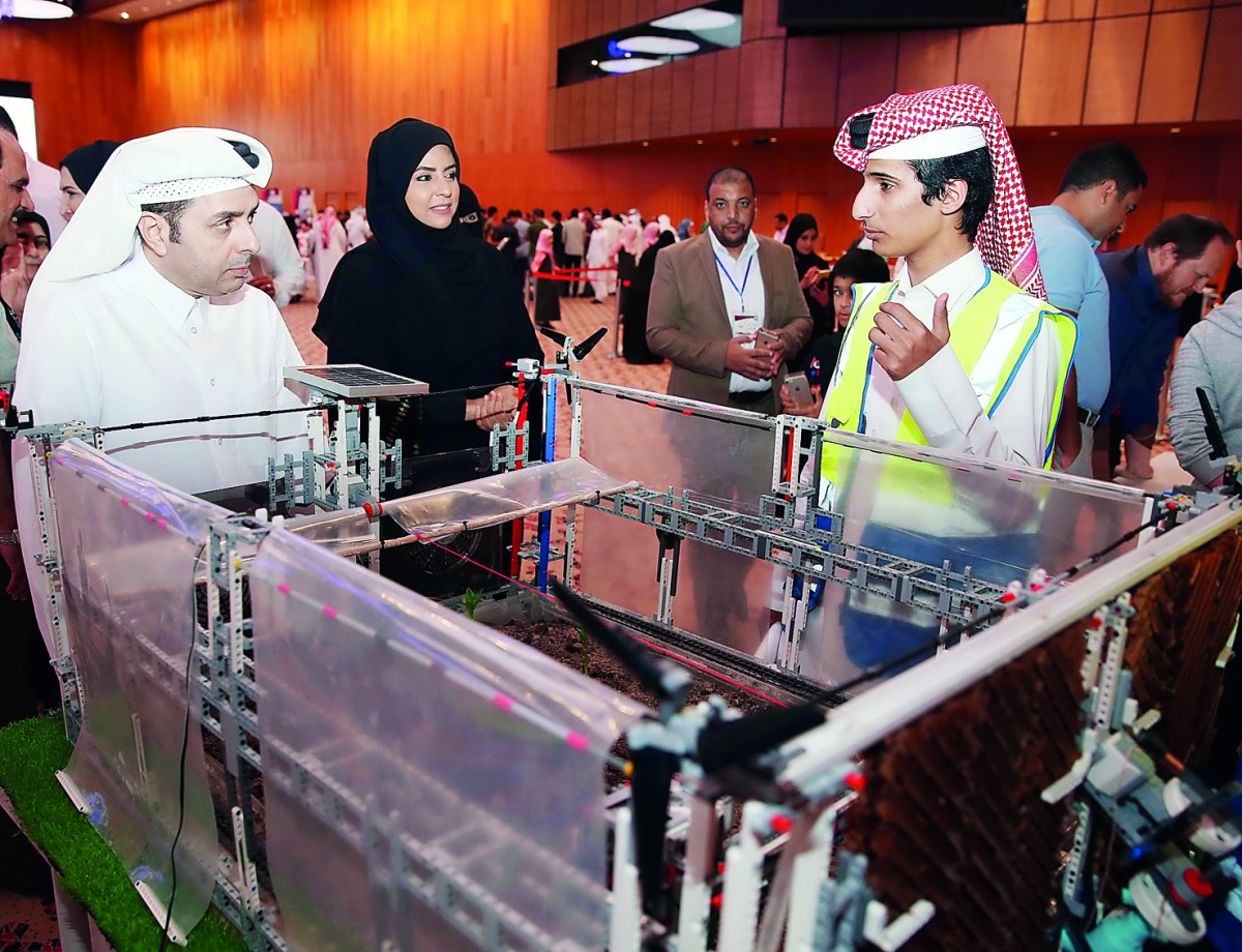 Minister of Education and Higher Education H E Dr Mohammed Abdul Wahed Ali Al Hammadi and Assistant Under-Secretary for Educational Affairs Fawziya Al Khater visiting one of the stalls during the Qatar National Robot Olympiad.