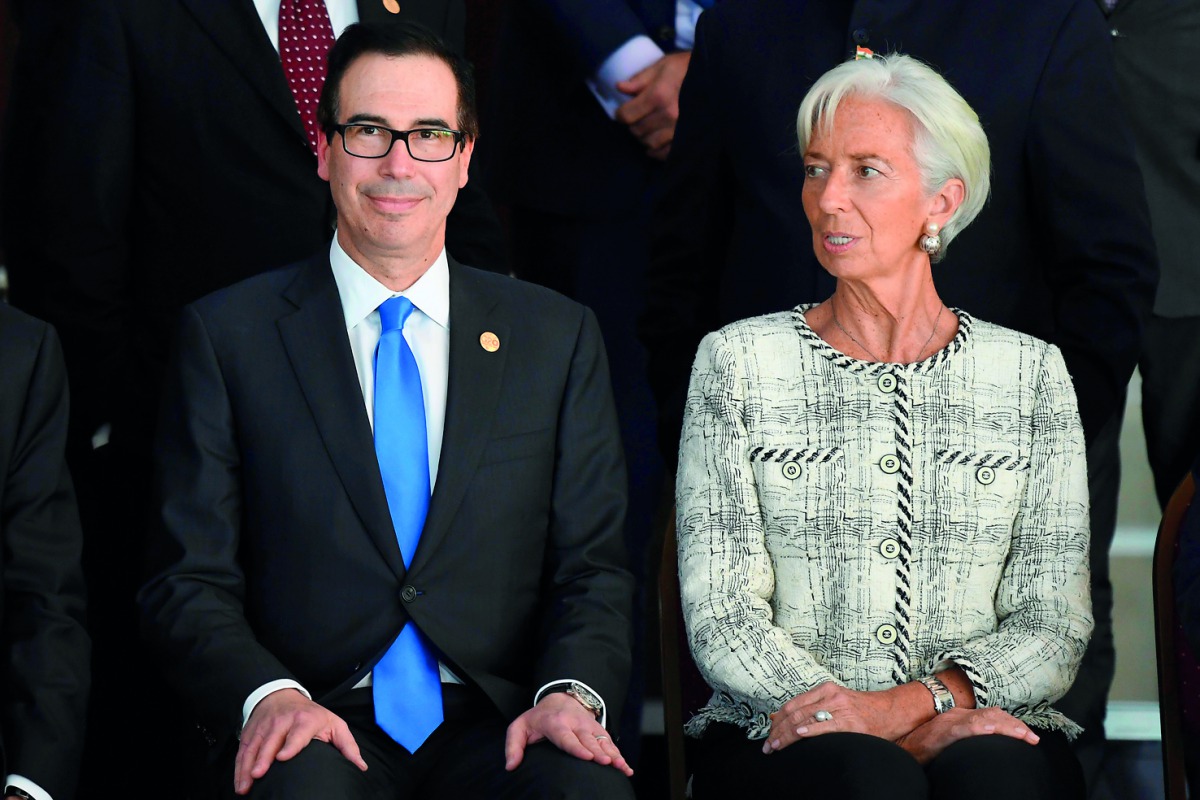 US Secretary of Treasury Steven Mnuchin (L) and IMF Managing Director Christine Lagarde sit for the family picture of the G20 Meeting of Finance Ministers and Central Bank Governors, in Buenos Aires, on March 19, 2018.  AFP / Eitan Abramovich    