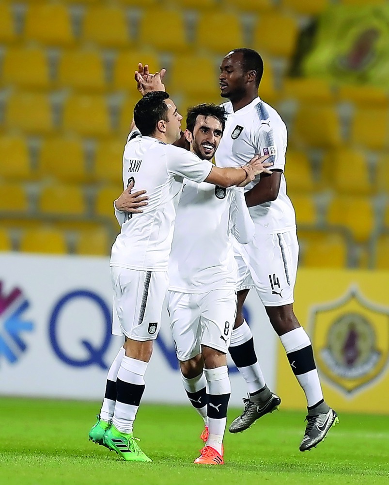 Al Sadd skipper Xavi Hernandez (left) celebrates with team-mates after scoring a goal during a QNB Stars League match in this file photo.
