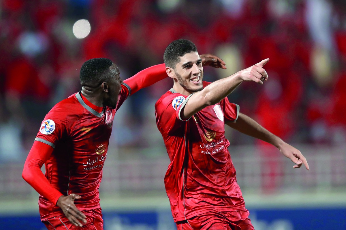 Al Duhail’s Karim Boudiaf (right) celebrates after scoring  during a QNB Stars League match in this file photo.