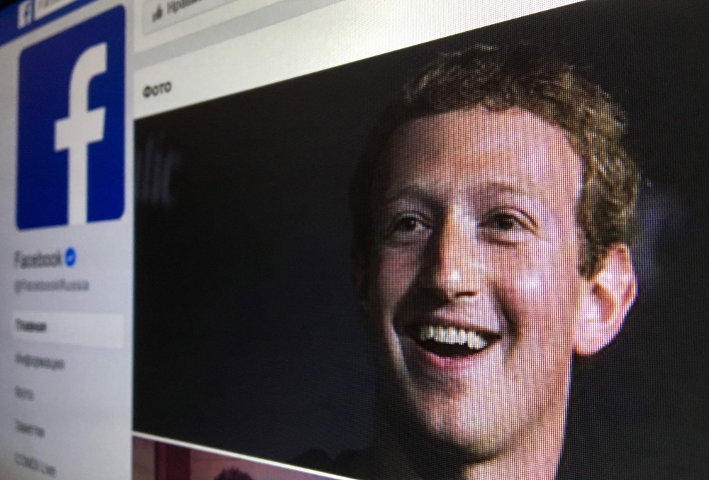 An illustration picture of the Russian language version of Facebook about page featuring the face of founder and CEO Mark Zuckerberg in a picture taken in Moscow on March 22, 2018. (AFP /  Mladen Antonov) 
