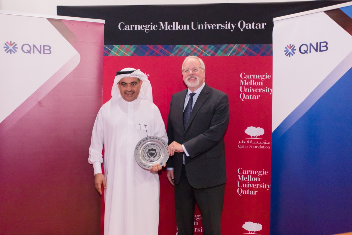Michael Trick, Dean of Carnegie Mellon University in Qatar, is presenting a memento to Ali Ahmed Al Kuwari, Group CEO of QNB.