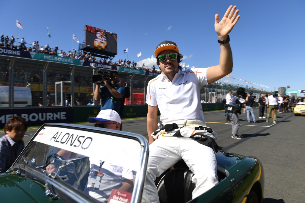 McLaren's Spanish driver Fernando Alonso waves to the crowd during the Drivers' Parade at the Albert Park circuit in Melbourne on March 25, 2018, ahead of the Formula One Australian Grand Prix.
