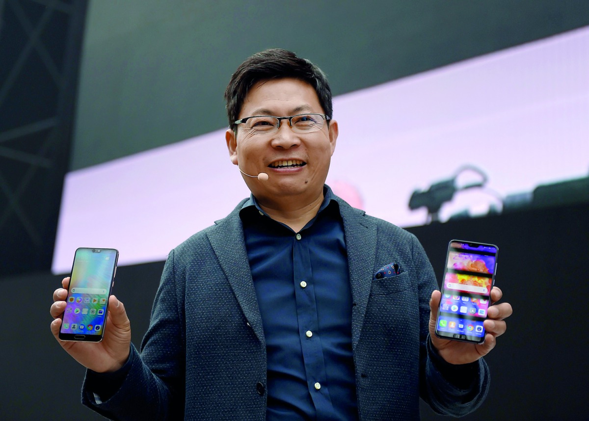 Telecom equipment company Huawei CEO Richard Yu presents the new P20 smartphone in Paris on March 27, 2018. AFP / Eric Piermont
