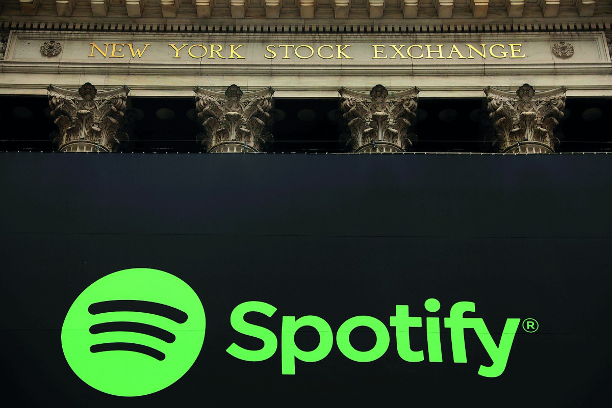 The Spotify logo hangs on the facade of the New York Stock Exchange as the company lists its stock with a direct listing in New York, U.S., April 3, 2018. Reuters/Lucas Jackson