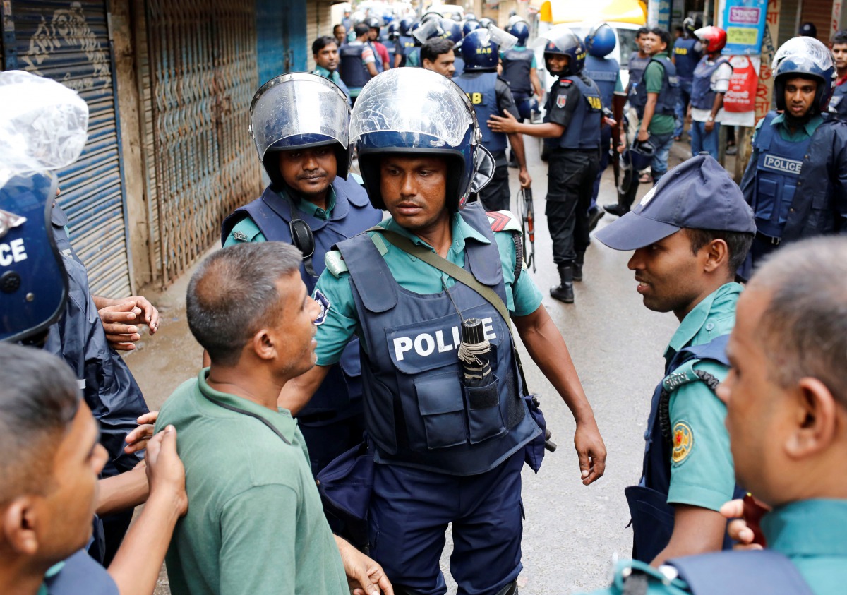FILE PHOTO: Police keep the public away near the site of a police operation on the outskirts of Dhaka, Bangladesh, July 26, 2016. Reuters/ Mohammad Ponir Hossain