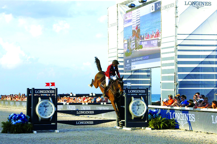 Qatar’s Bassem Mohammed guides Gunder over an obstacle during the event in Miami, USA.