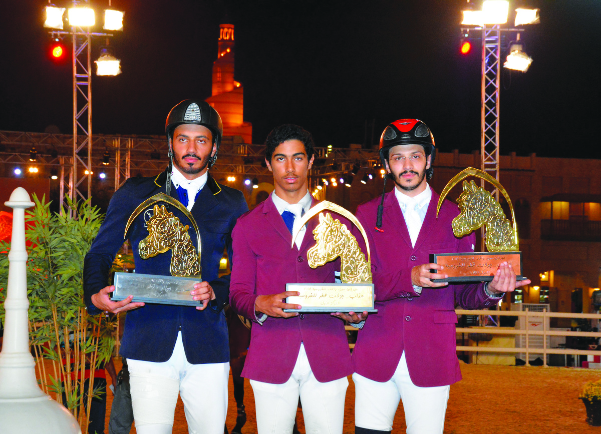 From left: Podium winners of the Small Tour, Saeed Nasser Al Qadi, Ghanim Nasser Al Qadi and Hamad Nasser Al Qadi pose for a photograph with their trophies at the Souq Waqif Arena yesterday. 