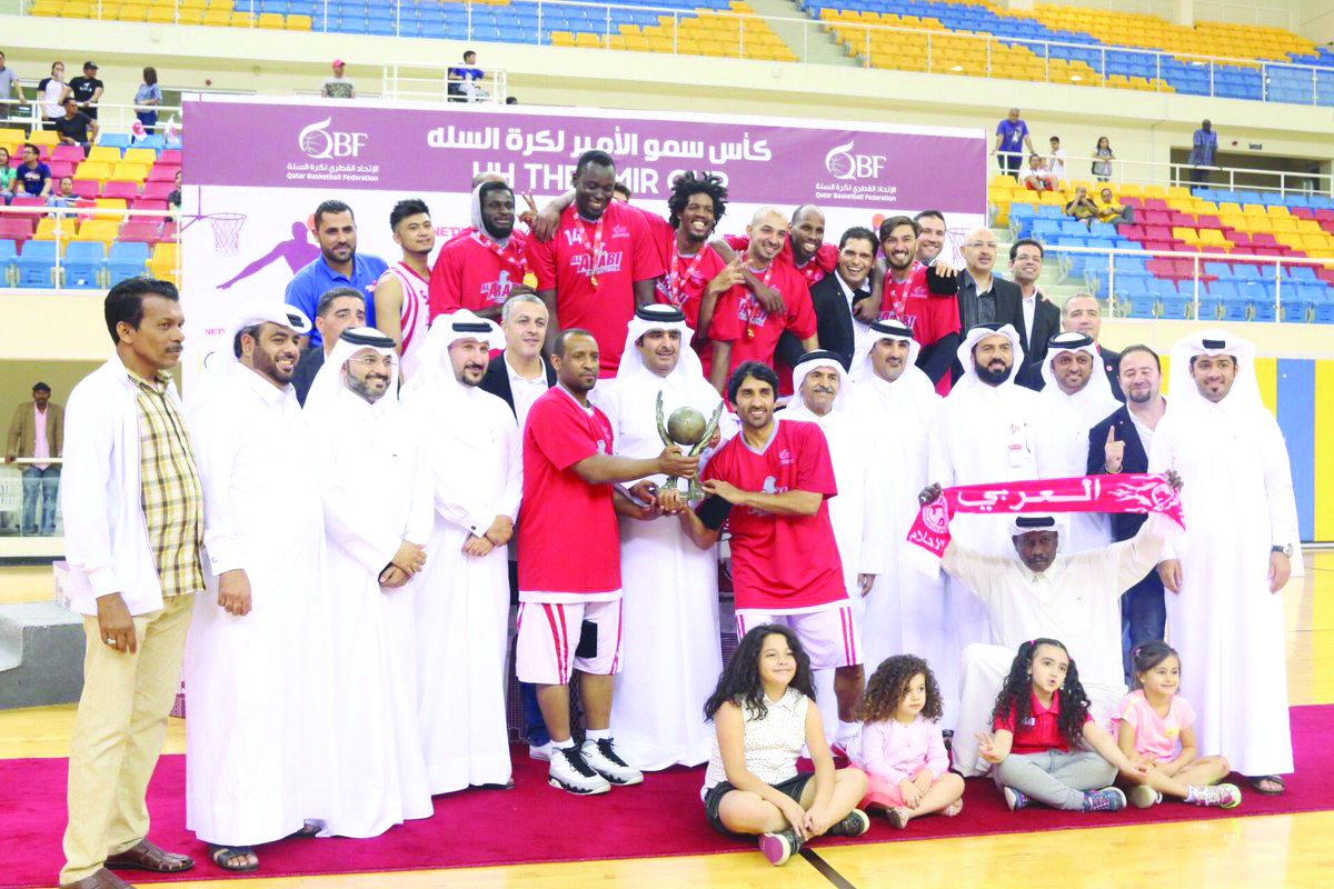 Al Arabi’s players and officials celebrate after winning the Emir Cup basketball final against Al Wakrah yesterday. 