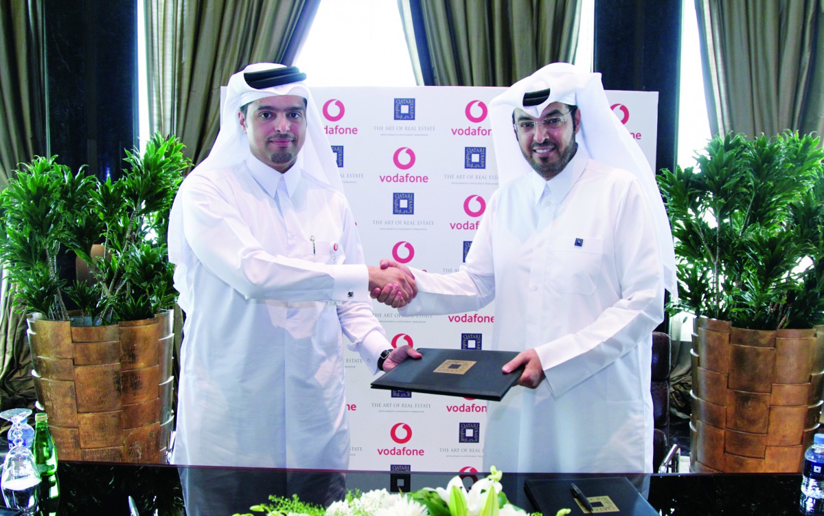 Sheikh Hamad Abdulla Jassim Al Thani (left), CEO, Vodafone Qatar; and Nabeel Al Buenain, CEO of Qatari Diar Real Estate Investment Company, shake hands after signing the agreement.