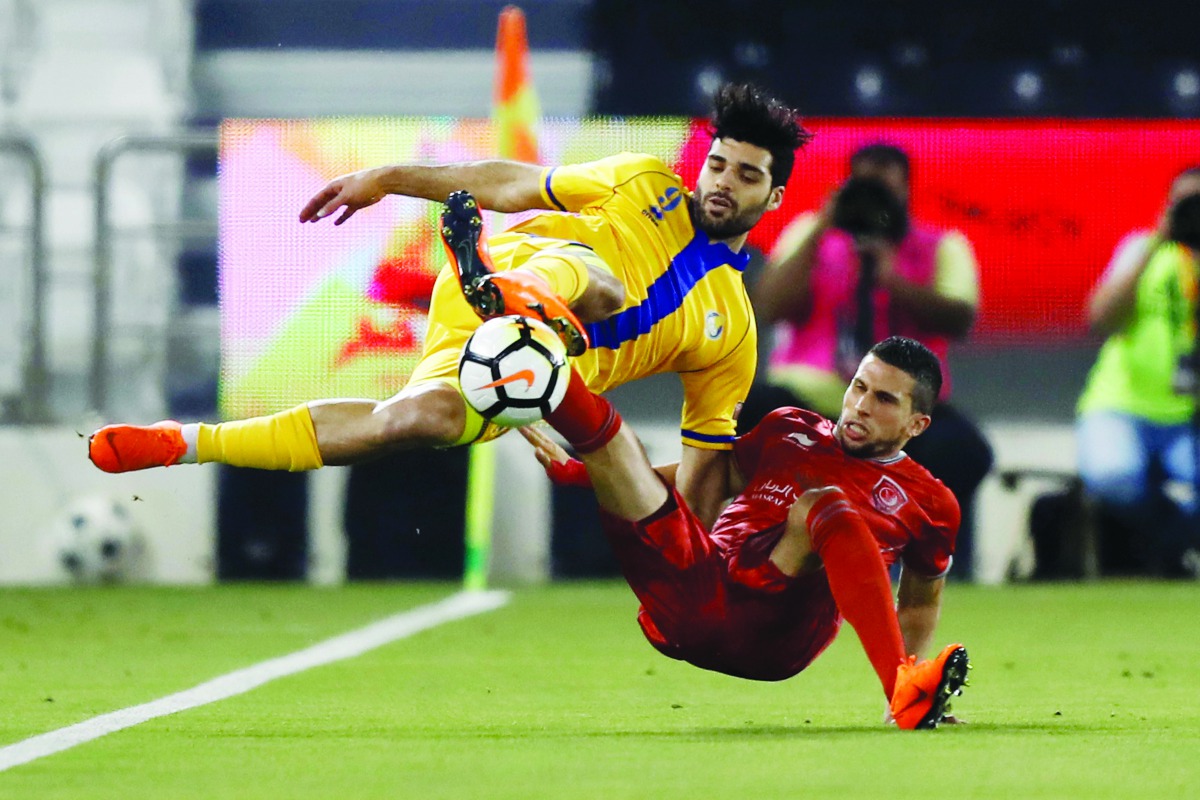 Al Duhail's Murad Naji vies for the ball posession against an Al Gharafa player during yesterday's Qatar Cup semi-final.
