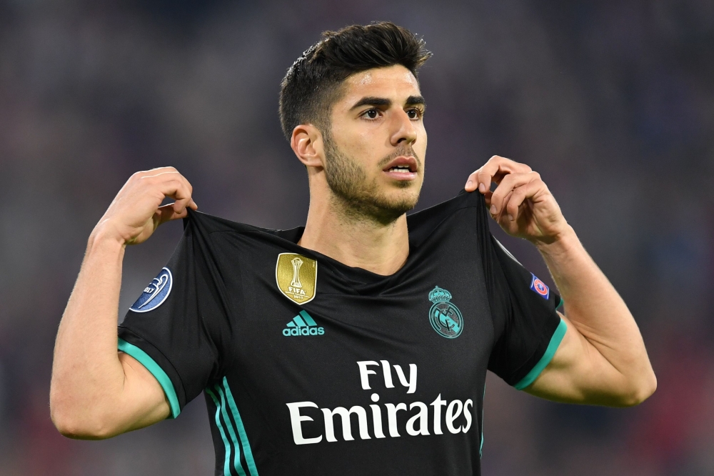 Real Madrid's Spanish midfielder Marco Asensio celebrates after scoring a goal during the UEFA Champions League semi-final first-leg football match FC Bayern Munich v Real Madrid CF in Munich in southern Germany on April 25, 2018. AFP / Christof Stache 
