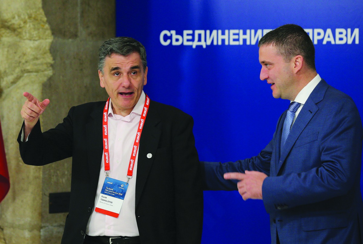 Greek Finance Minister Euclid Tsakalotos (left) speaks to Bulgaria’s Finance Minister Vladislav Goranov as he arrives for the Informal meeting of economic and financial affairs ministers (ECOFIN) in Sofia, Bulgaria, yesterday.