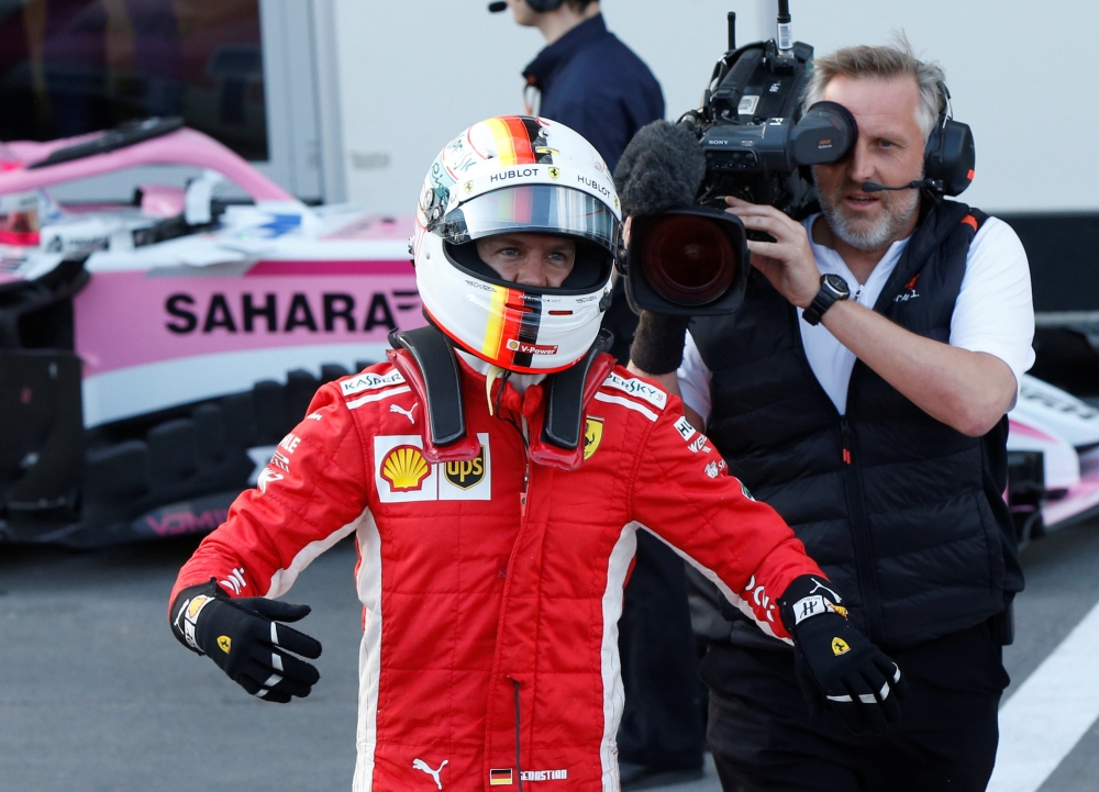 Ferrari's Sebastian Vettel celebrates winning the pole position REUTERS/David Mdzinarishvili
