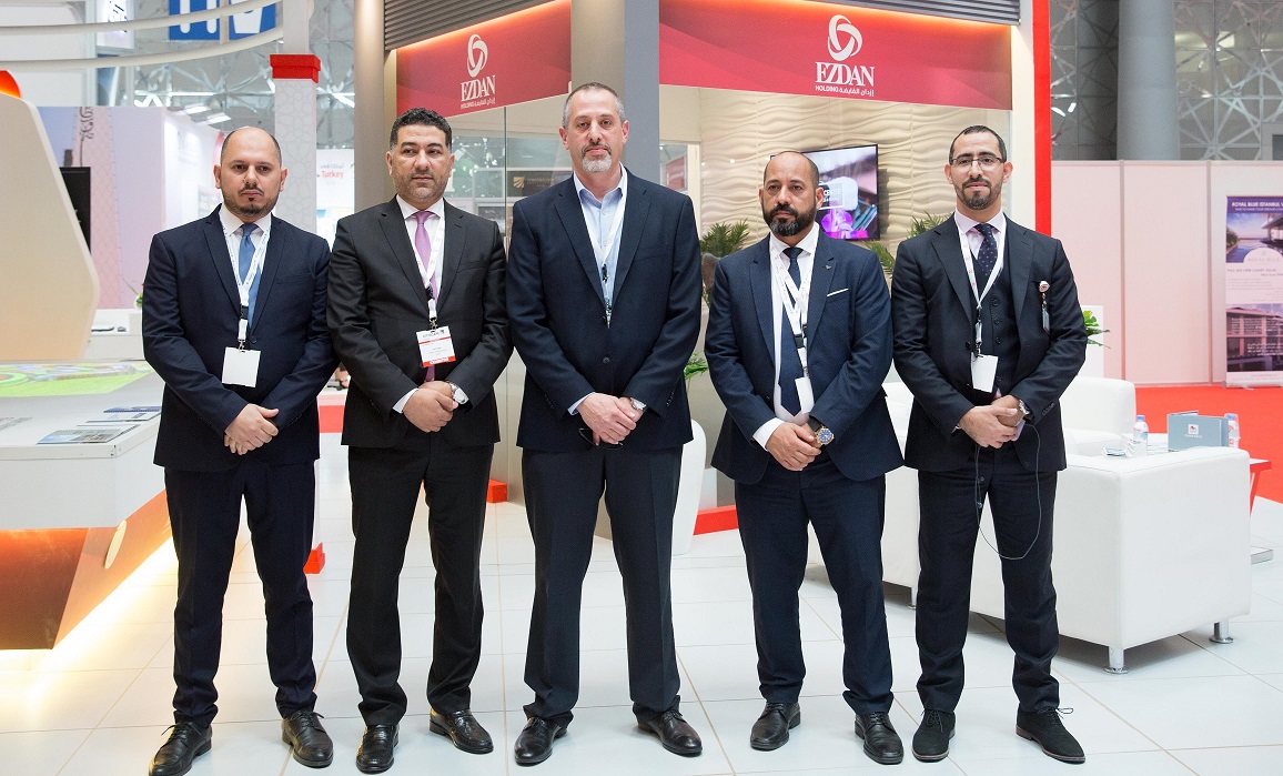 The officials of Ezdan Holding Group pose in front of it’s pavilion at the Citysacpe Qatar 2018  venue.
