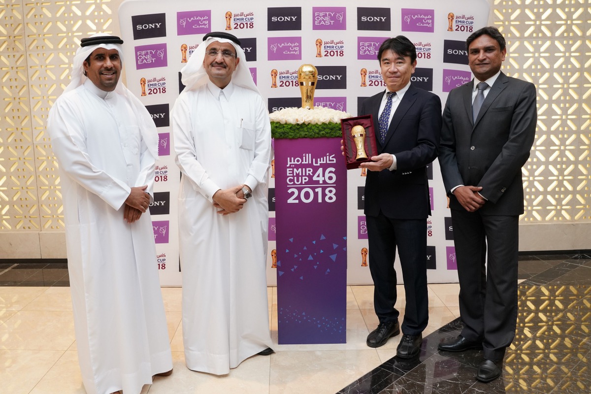 Qatar Football Association (QFA) and Fifty One East and Sony Middle East and Africa (Sony MEA) officials pose for a photographs with the Emir Cup. 