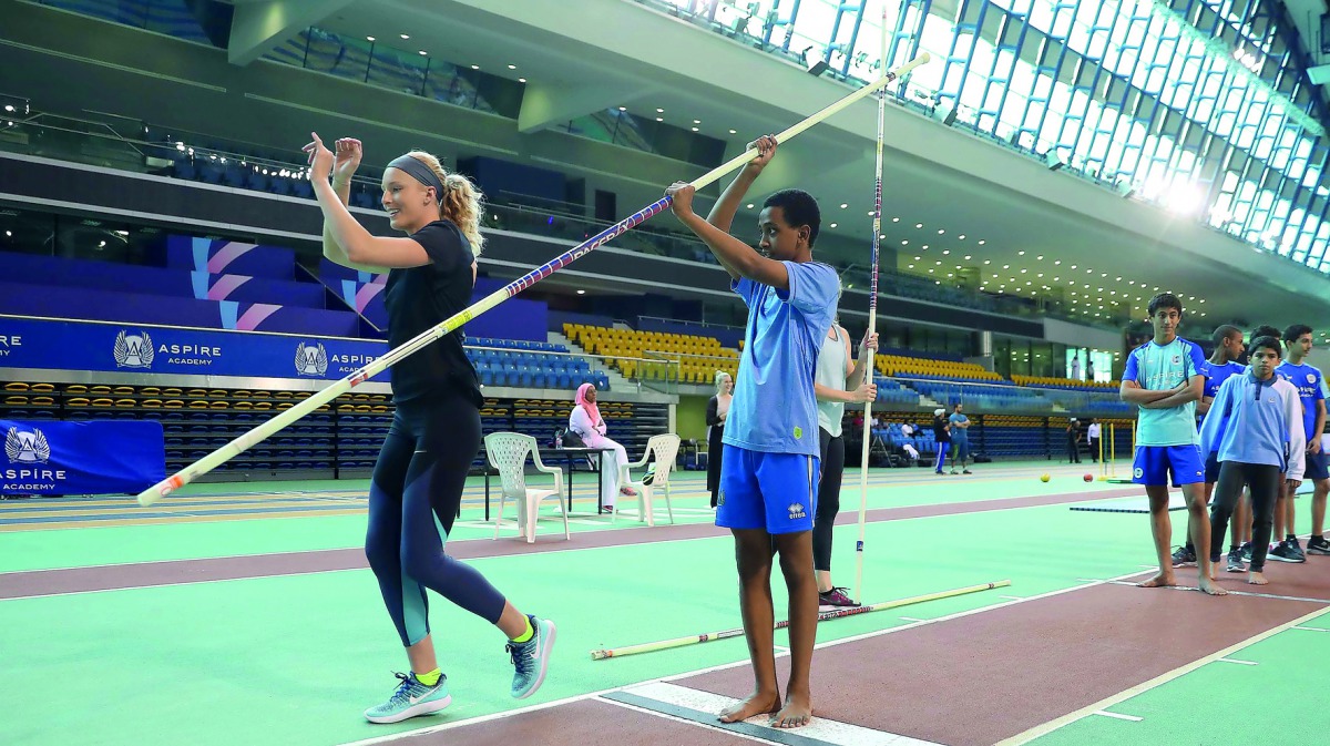 Olympic silver medallist Sandi Morris of the US demonstrating her pole vault skills to a schoolkid. 
