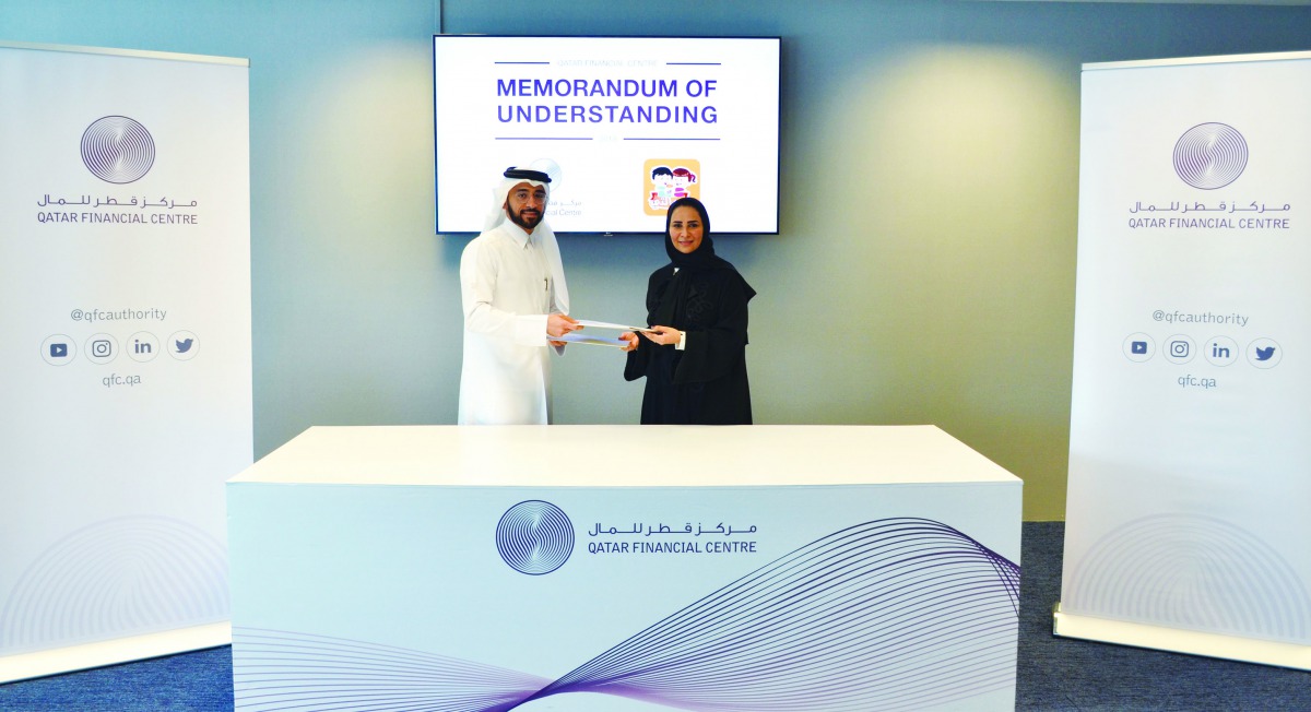Yousef Abdullah Fakhroo (left), Chief Marketing & Corporate Communications Officer, QFC Authority; and Noura Al Dossari, General Manager, Hasalty, exchange documents after signing the MoU.