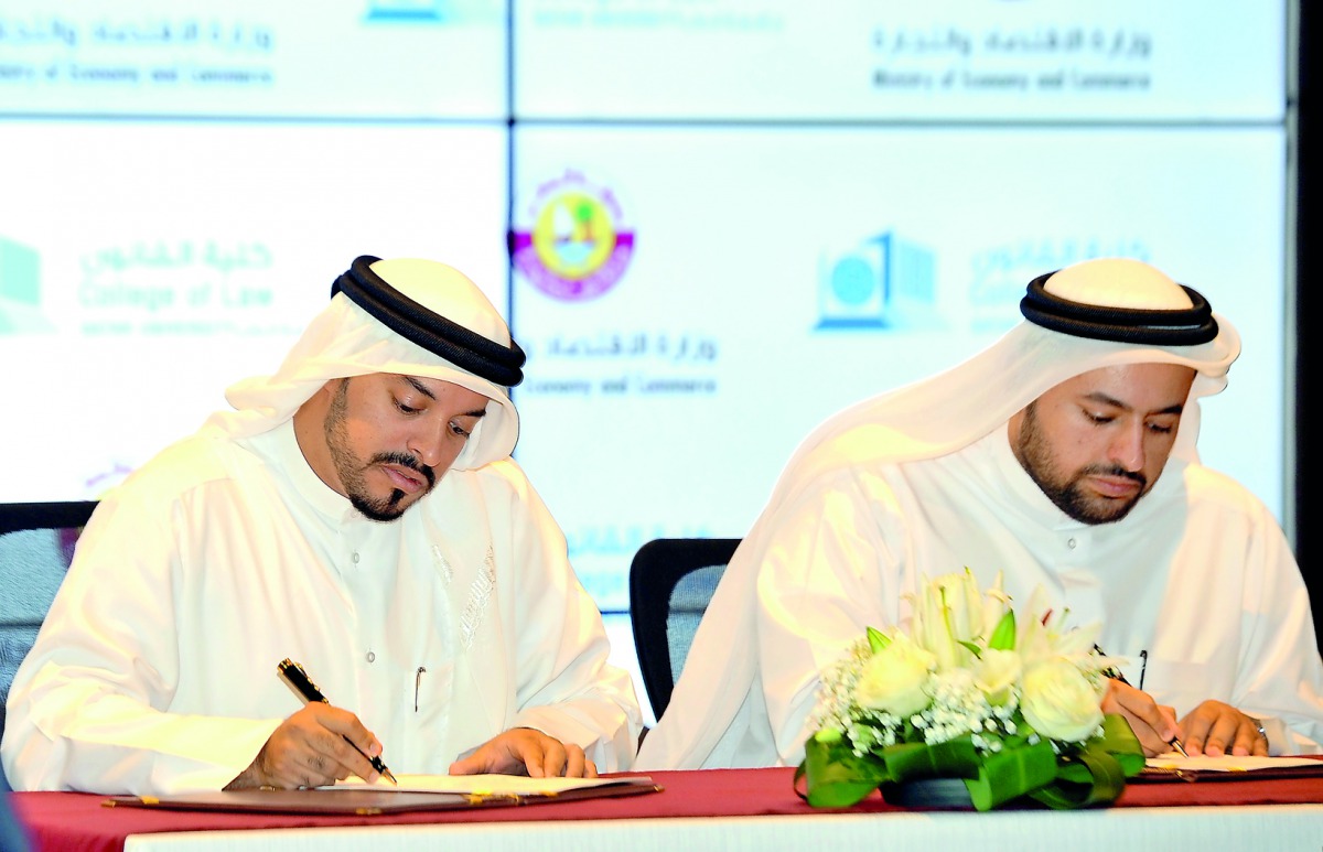 ilal Mohammed Al Khulaifi (left), Director, Legal Affairs Department, Ministry of Economy and Commerce, and  Dr Mohammed bin Abdul Aziz Al Khulaifi, Dean of the College of Law, QU, at the signing ceremony held at the Ministry’s headquarters in Lusail City