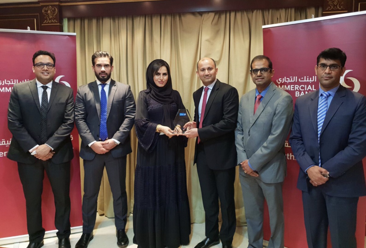Roya Khajeh (third left), Commercial Bank AGM and Head of Cards and Payments receiving the award from Shahebaz Khan (third right), Visa Country Manager for Qatar, as other officials look on