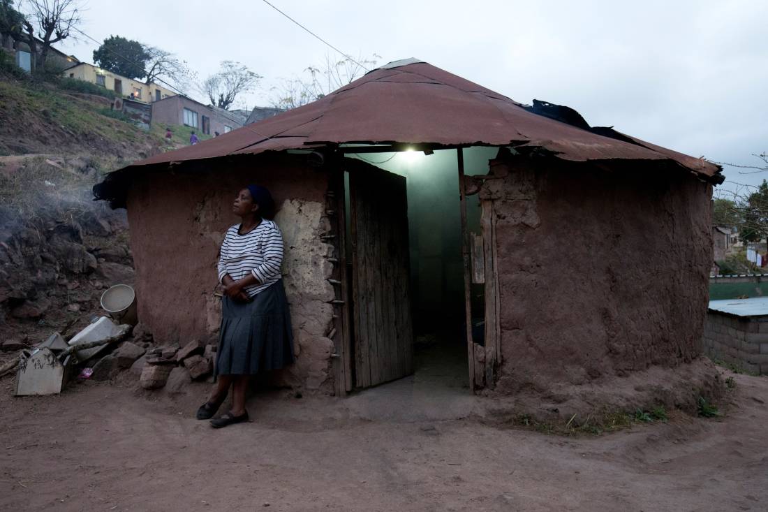 Fikile Mthiyane takes a break from cooking a family meal in KwaNdengezi, South Africa, August 31, 2017. REUTERS/Rogan Ward