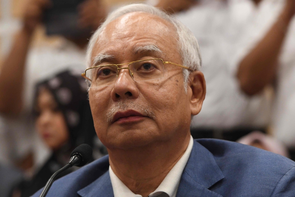 Former Malaysian prime minister Najib Razak attends a press conference to announce his resignation as president of the United Malays National Organisation (UMNO), the main component party of the defeated Barisan Nasional (BN) coalition, in Kuala Lumpur on