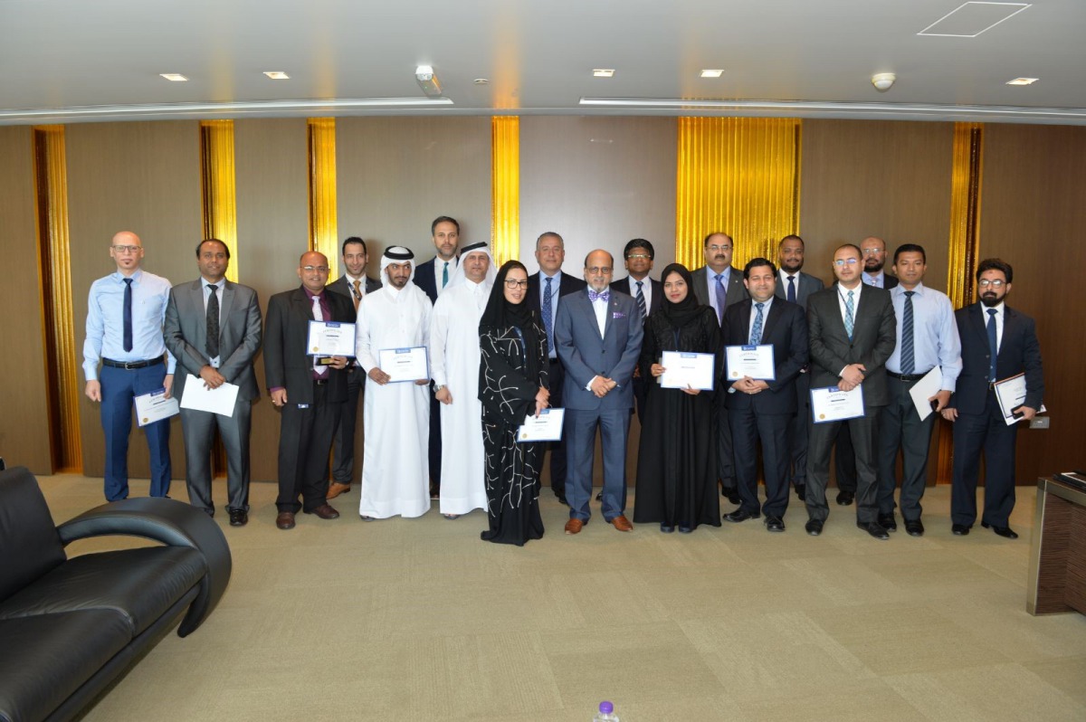 Dr. R Seetharaman, CEO of Doha Bank, with other officials and employees who have won the awards, during the event.
