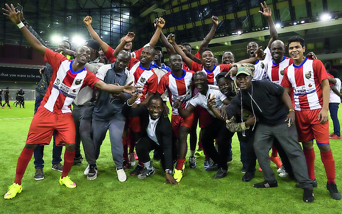 Champion ALYSJ FC players and officials celebrate after defeating MTM (Q Gym) in the final of the Qatar Community Football League at the Aspire Dome on Friday.