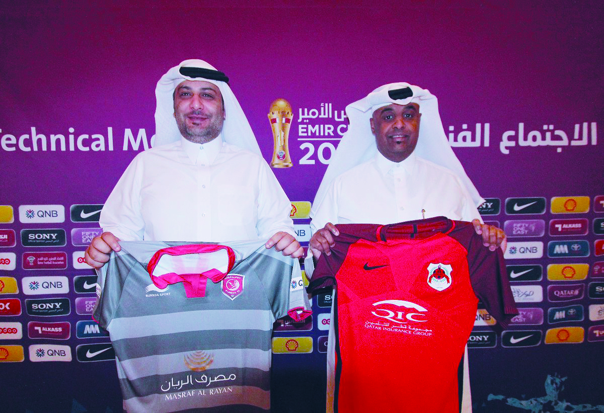 Officials display the team jerseys of Al Duhail and Al Rayyan ahead of the final of the Amir Cup.