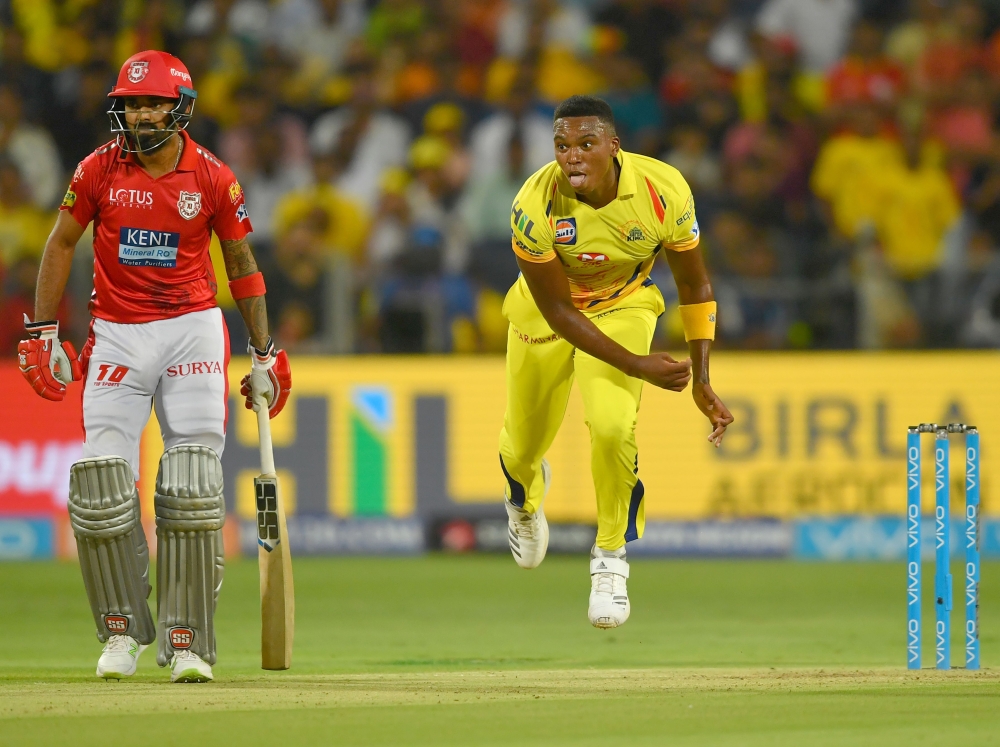Kings XI Punjab cricketer KL Rahul (L) looks on as Chennai Super Kings cricketer Lungi Ngidi bowls during the 2018 Indian Premier League (IPL) Twenty20 cricket match between Chennai Super Kings and Kings XI Punjab at the Maharashtra Cricket Association St