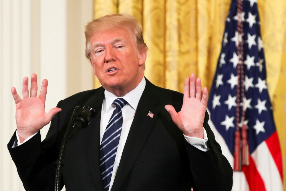 FILE PHOTO: US President Donald Trump gestures as he delivers remarks during the Prison Reform Summit at the White House in Washington, DC, US, May 18, 2018. REUTERS/Kevin Lamarque/File Photo