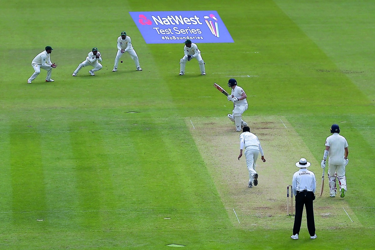 England's Dominic Bess (C) is caught by Pakistan's Asad Shafiq (2L), off the bowling of Pakistan's Mohammad Abbas (CL) for five, on the first day of the first international Test match between England and Pakistan at Lord's cricket ground in London on May 