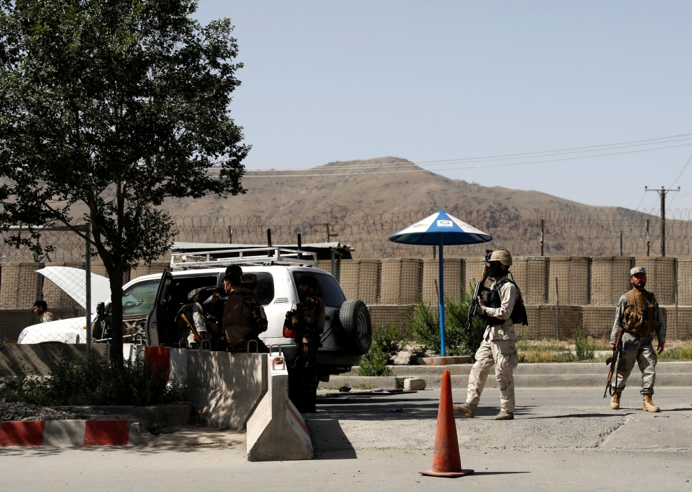 Afghan security forces inspect them at the gate of an Interior ministry after an attack in Kabul, Afghanistan May 30, 2018. REUTERS/Mohammad Ismail