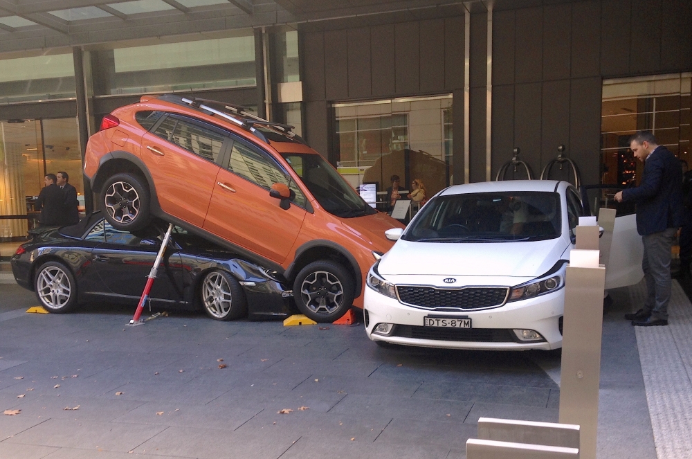 Hotel staff and guests can be seen near a car accident outside the main entrance of a hotel located in the central business district (CBD) of Sydney, Australia, May 31, 2018. REUTERS/Paul Tait
