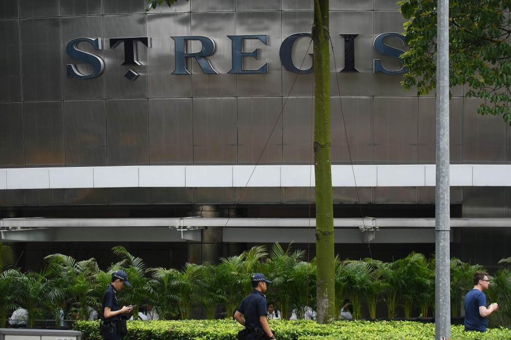 Policemen patrol outside the St. Regis hotel premises ahead of the US-North Korea summit in Singapore on June 10, 2018. AFP / ADEK BERRY
 