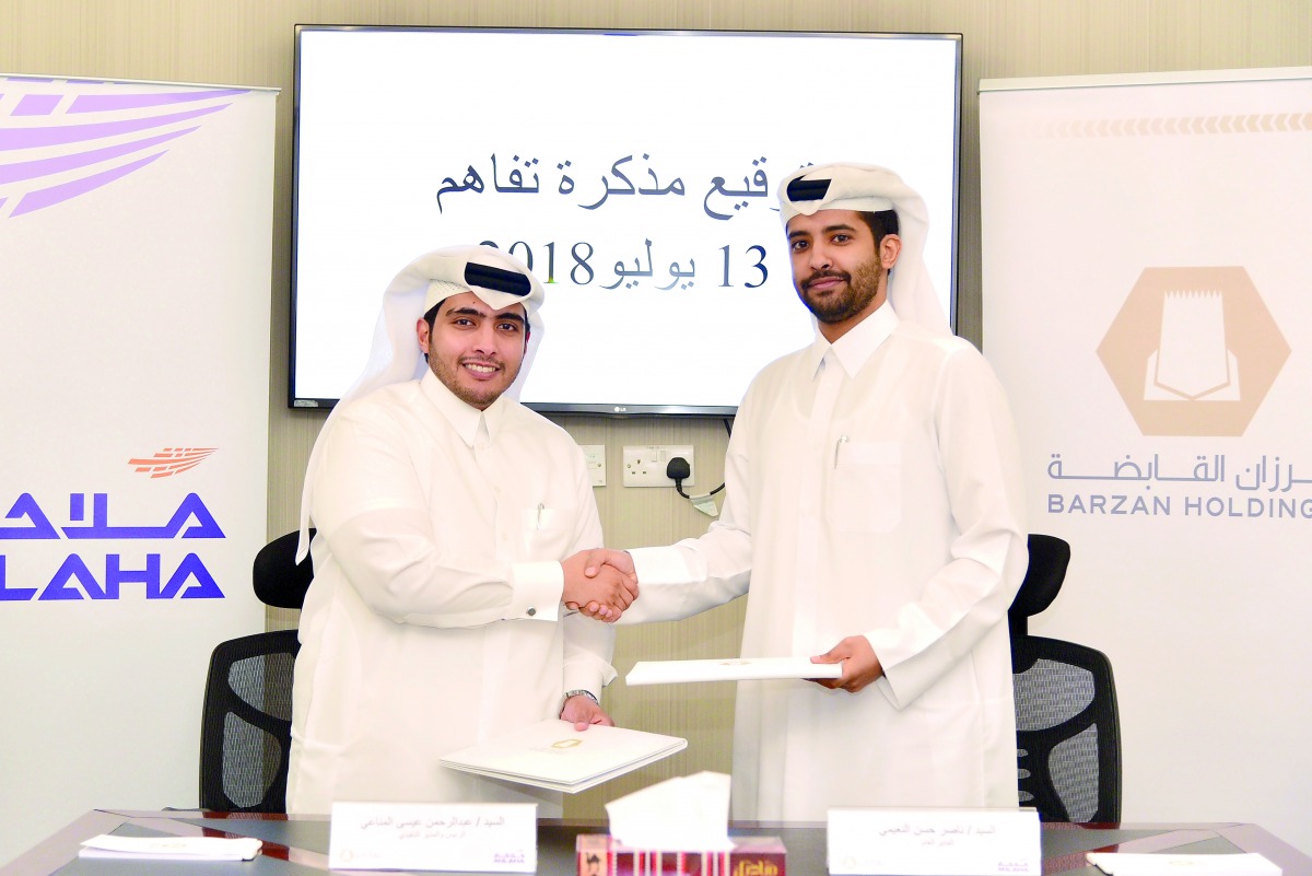 Abdulrahman Essa Al Mannai (left), President and CEO of Milaha, and Nasser Hassan Al Naimi, Managing Director of Barzan Holdings, after signing the MoU, yesterday.