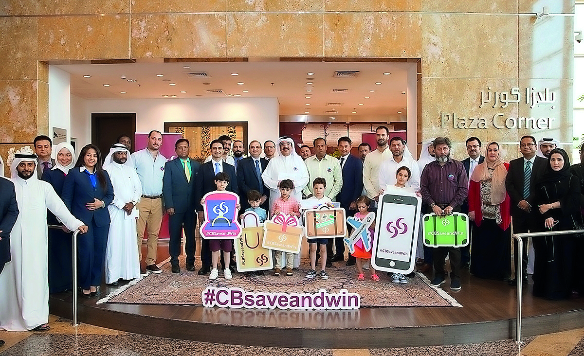 Commercial Bank officials with some of the April and May draw winners of ‘Save & Win’ campaign, at the bank headquarters, in West Bay.