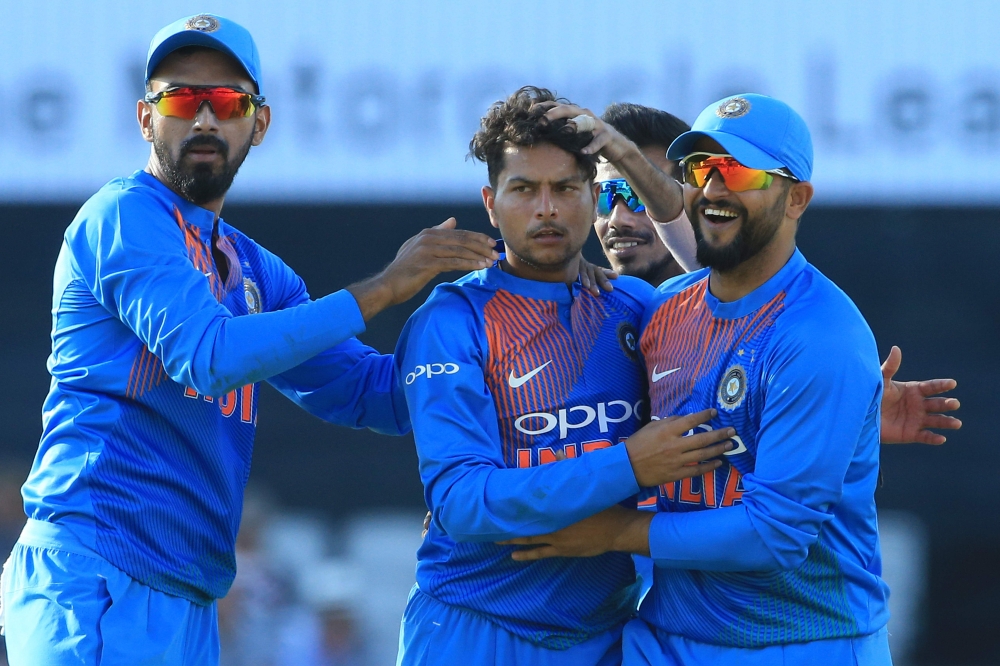India's Kuldeep Yadav (C) celebrates after taking the wicket of England's Jos Buttler during the international Twenty20 cricket match between England and India at Old Trafford cricket ground in Manchester, northwest England, on July 3, 2018. ECB / AFP / T