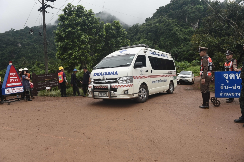 Ambulance head to Tham Luang cave area as divers began evacuation of the 12 boys and their coach trapped at the cave in Khun Nam Nang Non Forest Park in the Mae Sai district of Chiang Rai province on July 8, 2018. (AFP / Lillian SUWANRUMPHA)