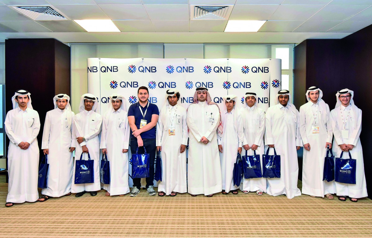 QNB officials with the students within QCDC’s career camp 2018, during their visit to the bank’s Mathaf building.