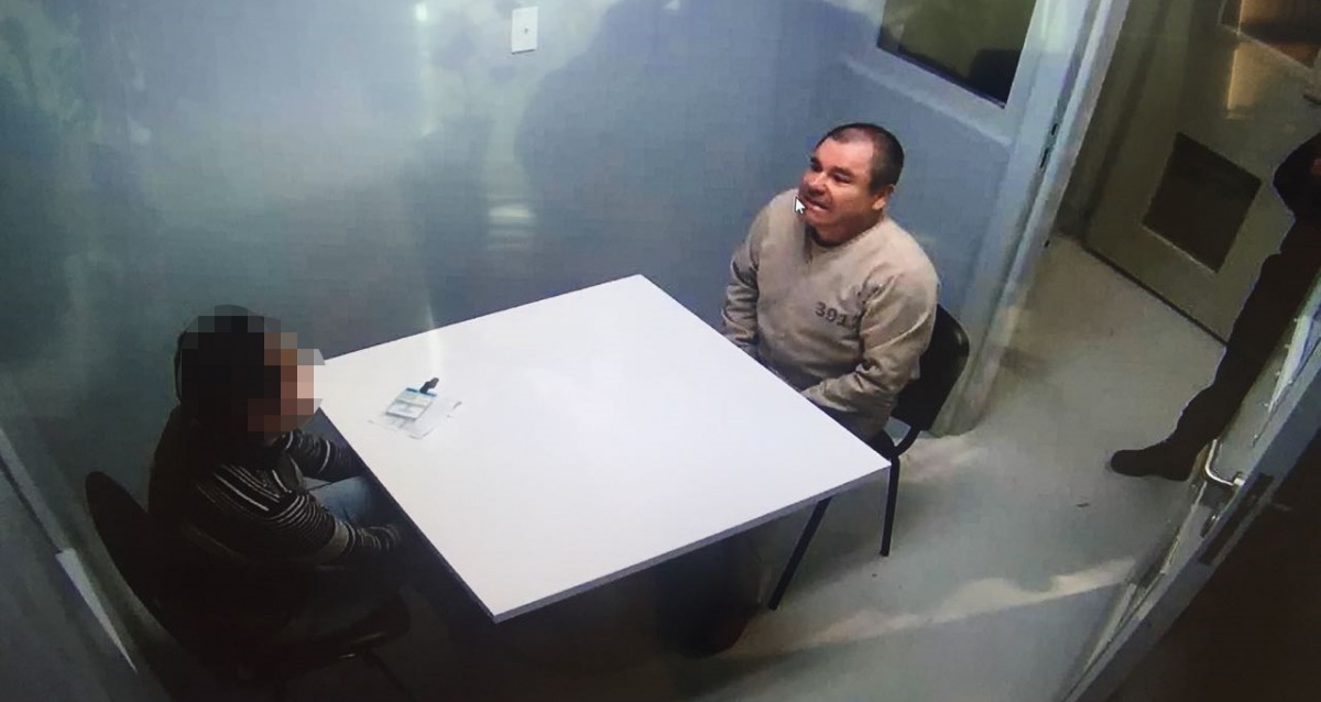 Handout picture released by the Mexican Interior Ministry on January 20, 2017 shows Joaquin Guzman Loera aka El Chapo Guzman (R) sitting in a chair as he is extradited to the US in an unknowen location (AFP) 