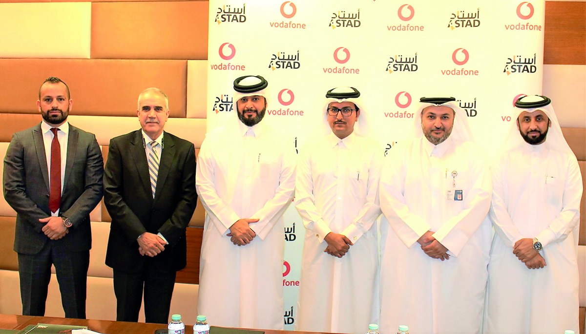 Mahday Al Hebabi (third right), Vodafone Qatar’s Head of Large Sales; and Abdulla Alyafei (second right), ASTAD’s IT Director;  with other ASTAD and Vodafone senior executives during the signing ceremony.